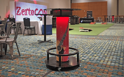 Red branded charging table in conference room for an event