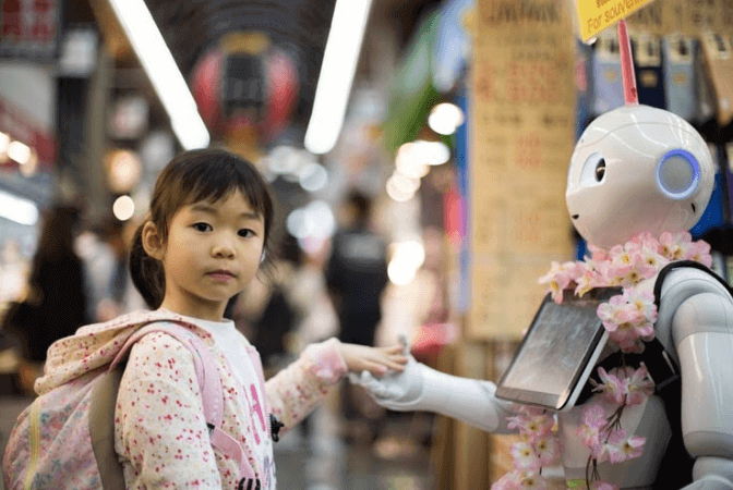 Girl holding hand of interactive robot
