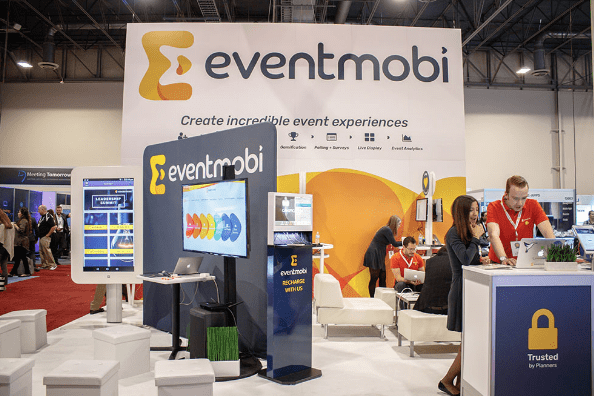 EventMobi trade show booth at IMEX convention center in Las Vegas with cell phone charging station