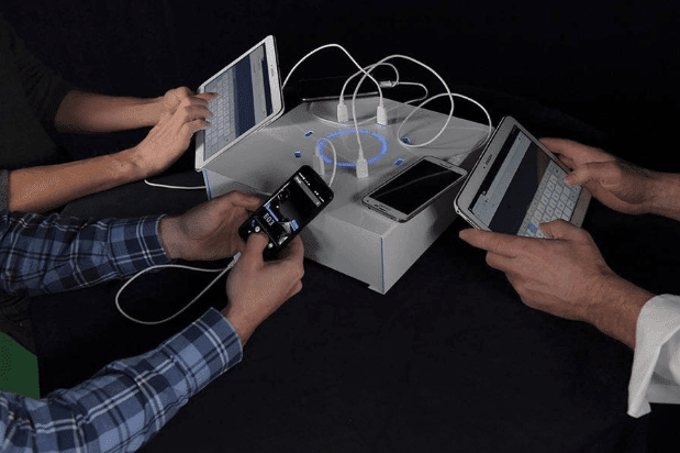 power box tabletop charging station tablets and phones people using black background