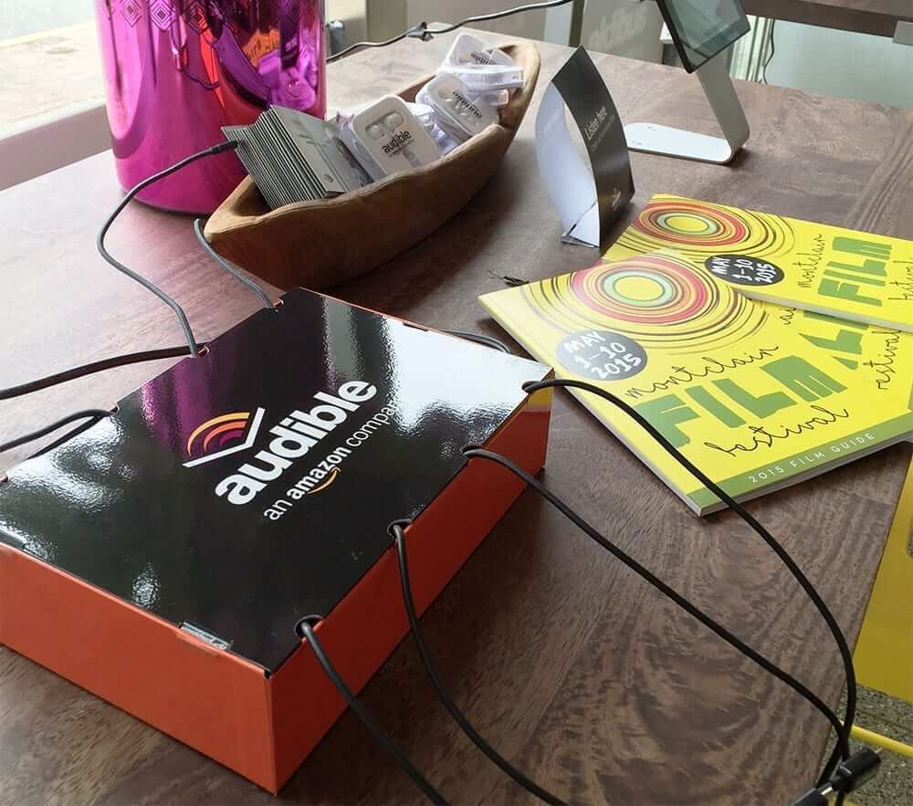 Audible branded tabletop cell phone charging station at event